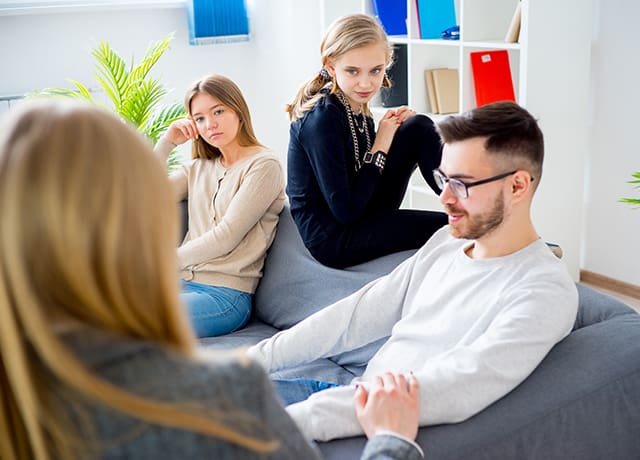 A group of people sitting on top of a couch.